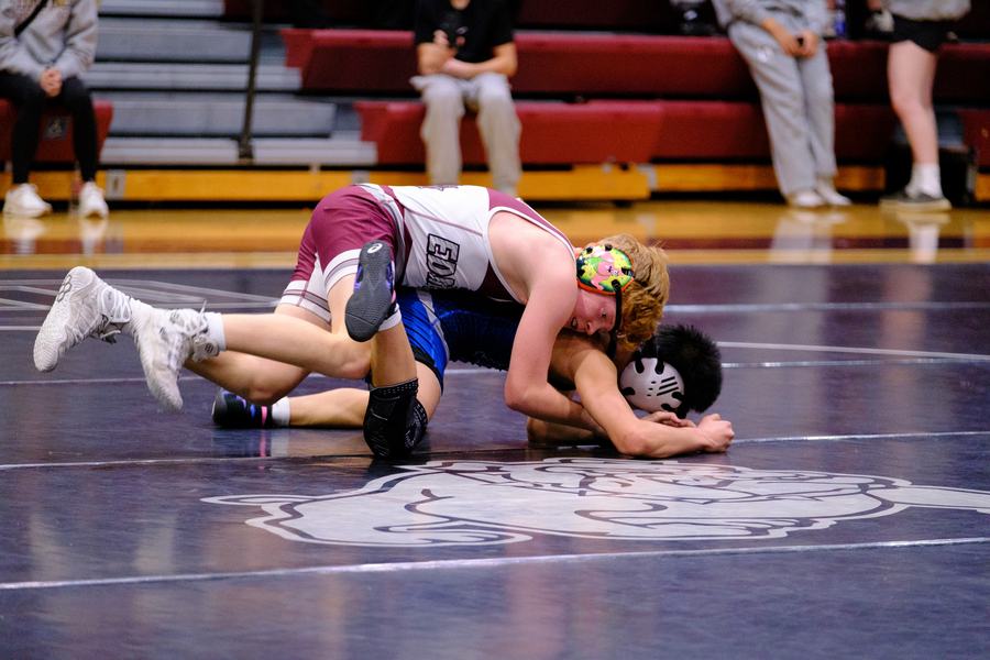 An Edmond Memorial wrestler works from the top position