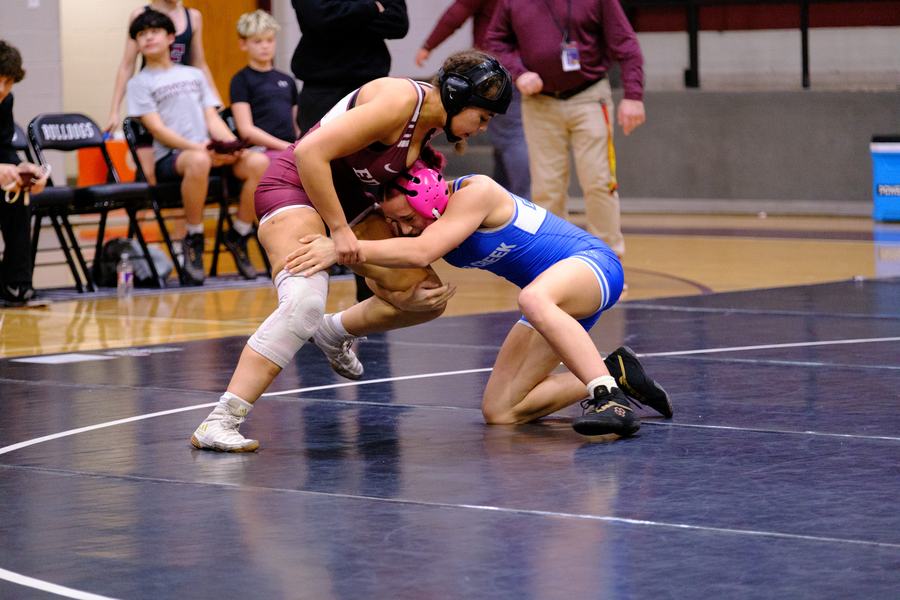 An Edmond wrestler drives in on a shot